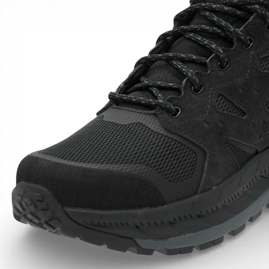 Black hiking boot with detailed sole design on a white background