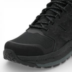 Black hiking boot with detailed sole design on a white background