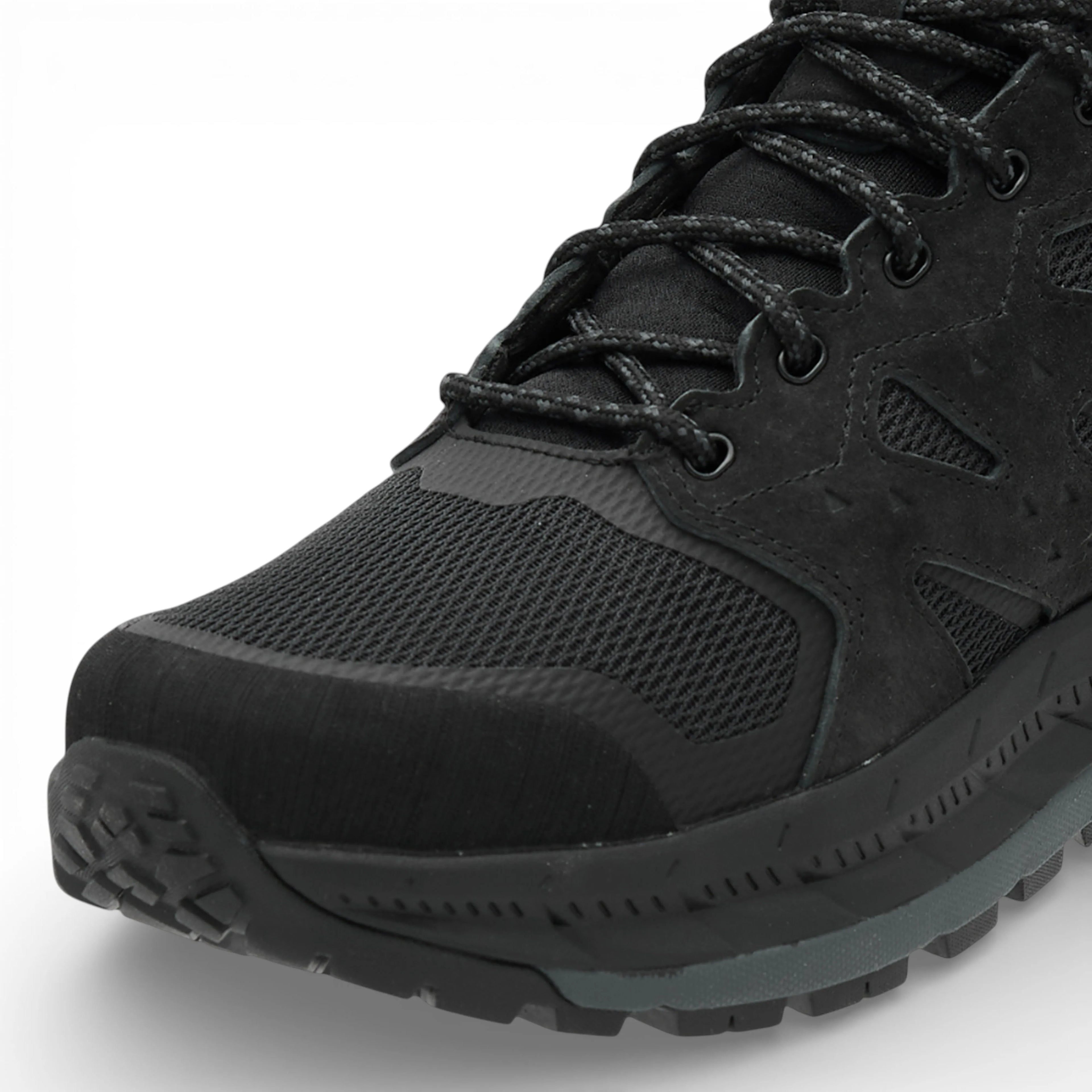 Black hiking boot with detailed sole design on a white background