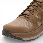 Brown hiking boot with a textured sole on a light gray background