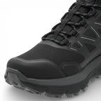 Black hiking boot with laces on a white background