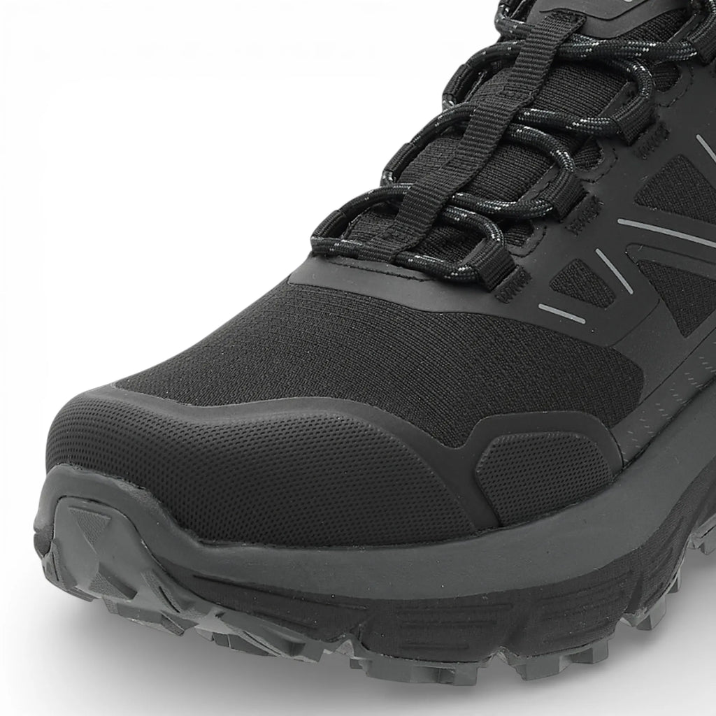 Black hiking boot with thick sole on a white background