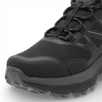 Black hiking boot with thick sole on a white background