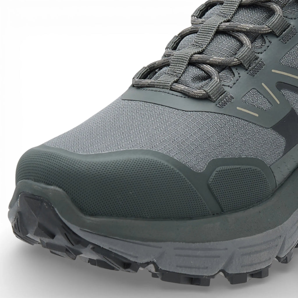 Gray hiking shoe with textured sole on a light gray background