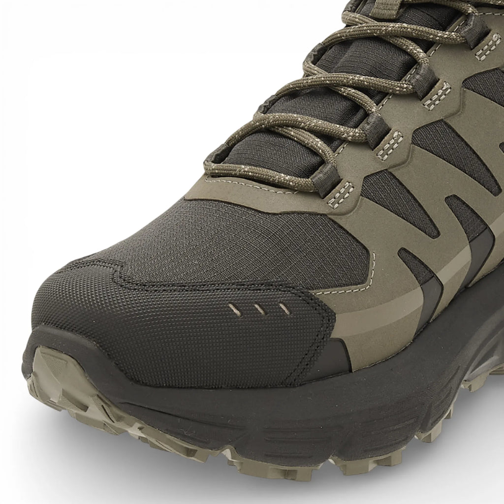 Green and black hiking boot on a white background