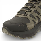 Green and black hiking boot on a white background