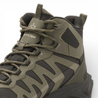 Green and black hiking boot on a white background
