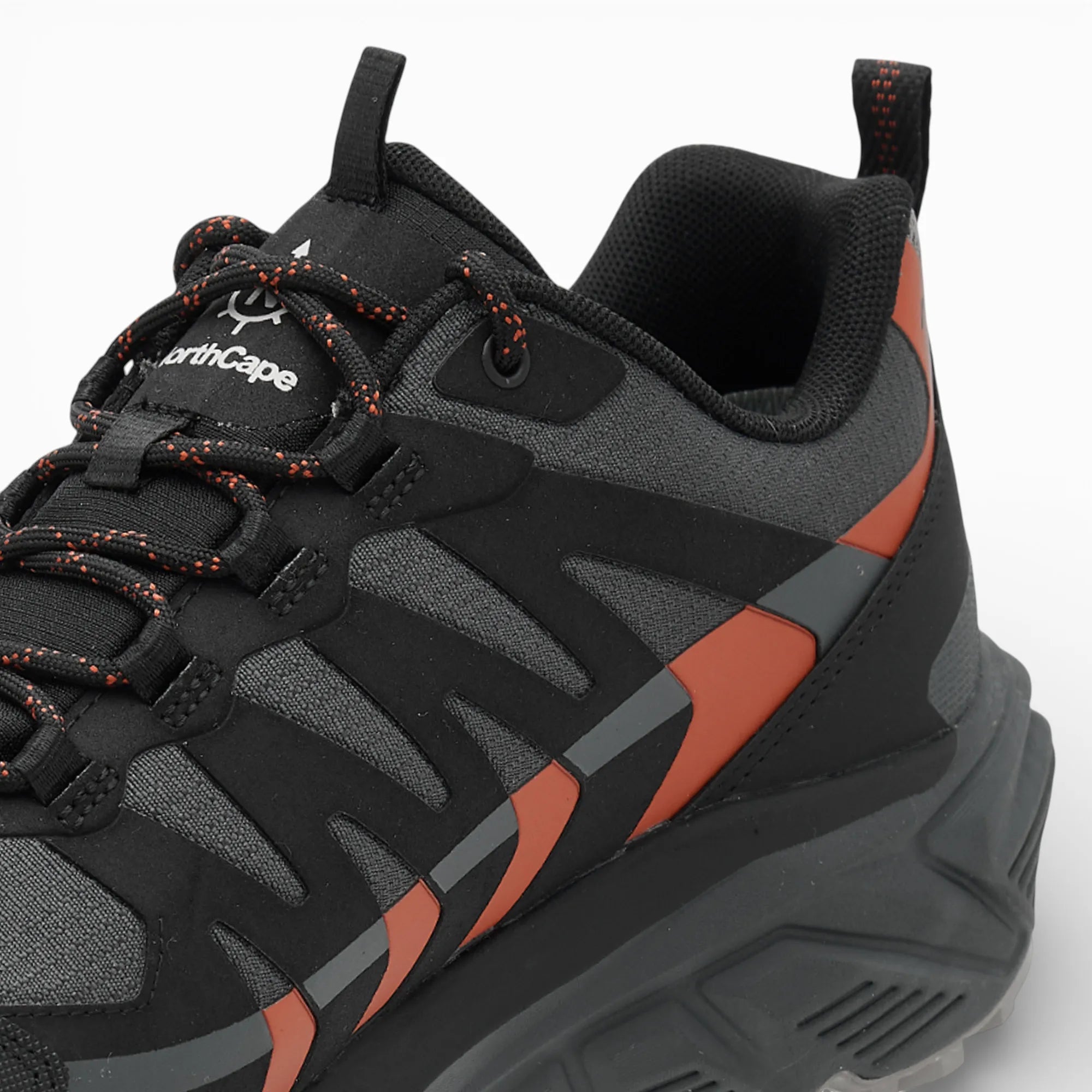 Black and orange sneaker with visible branding on a white background