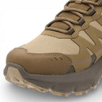 Brown and beige hiking shoe with a textured sole on a white background