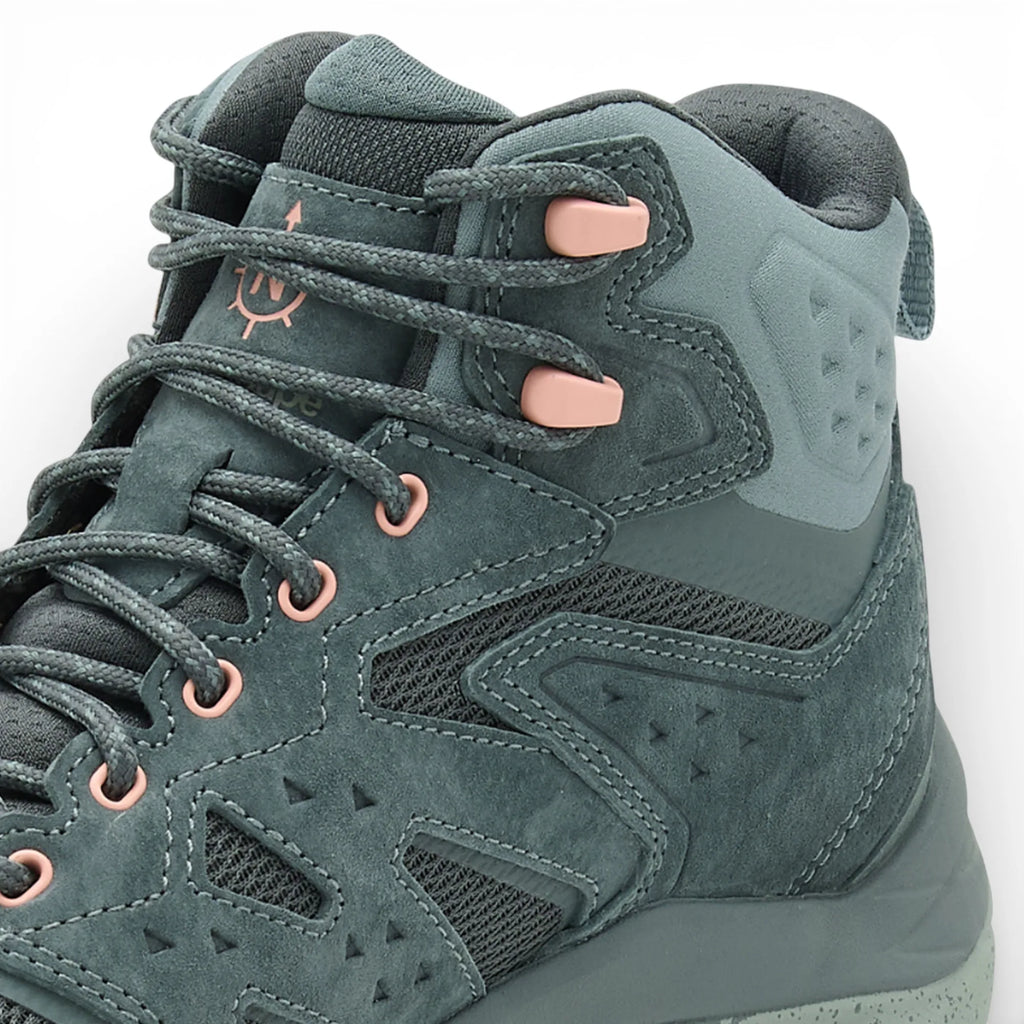 Green hiking boot with pink laces on a white background