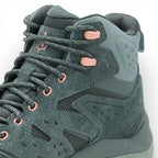 Green hiking boot with pink laces on a white background