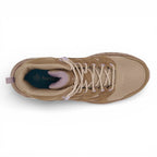 Tan sneaker with visible brand logo on a white background