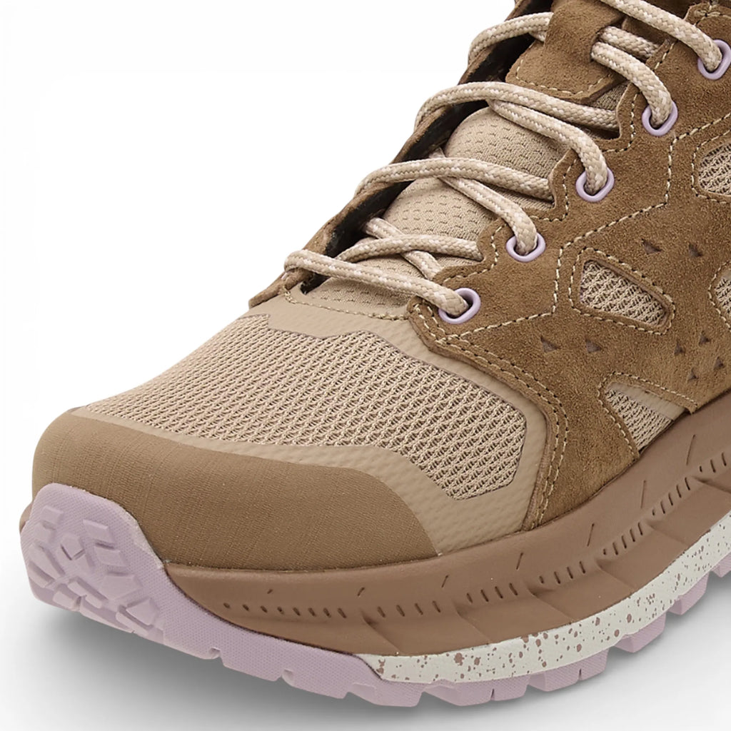 Beige hiking shoe with a textured sole on a white background
