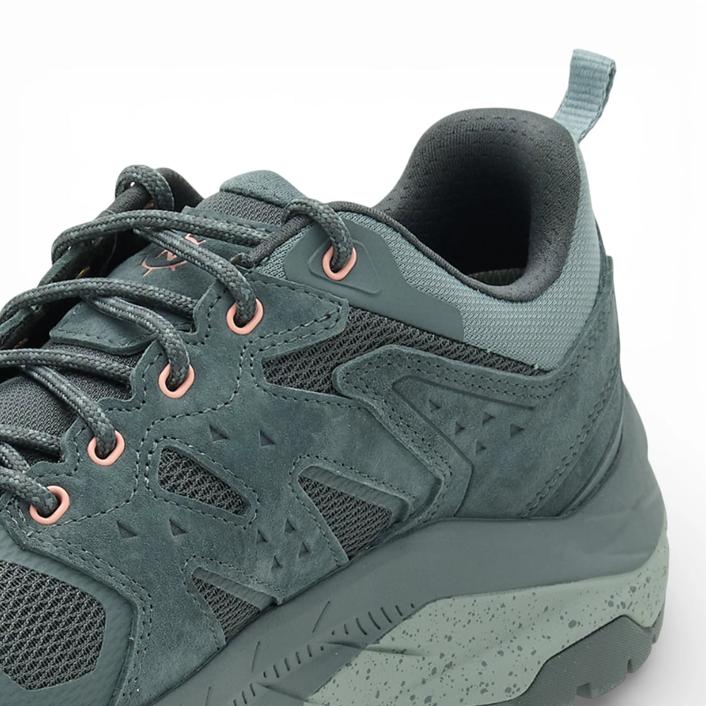 Green hiking shoe on a white background