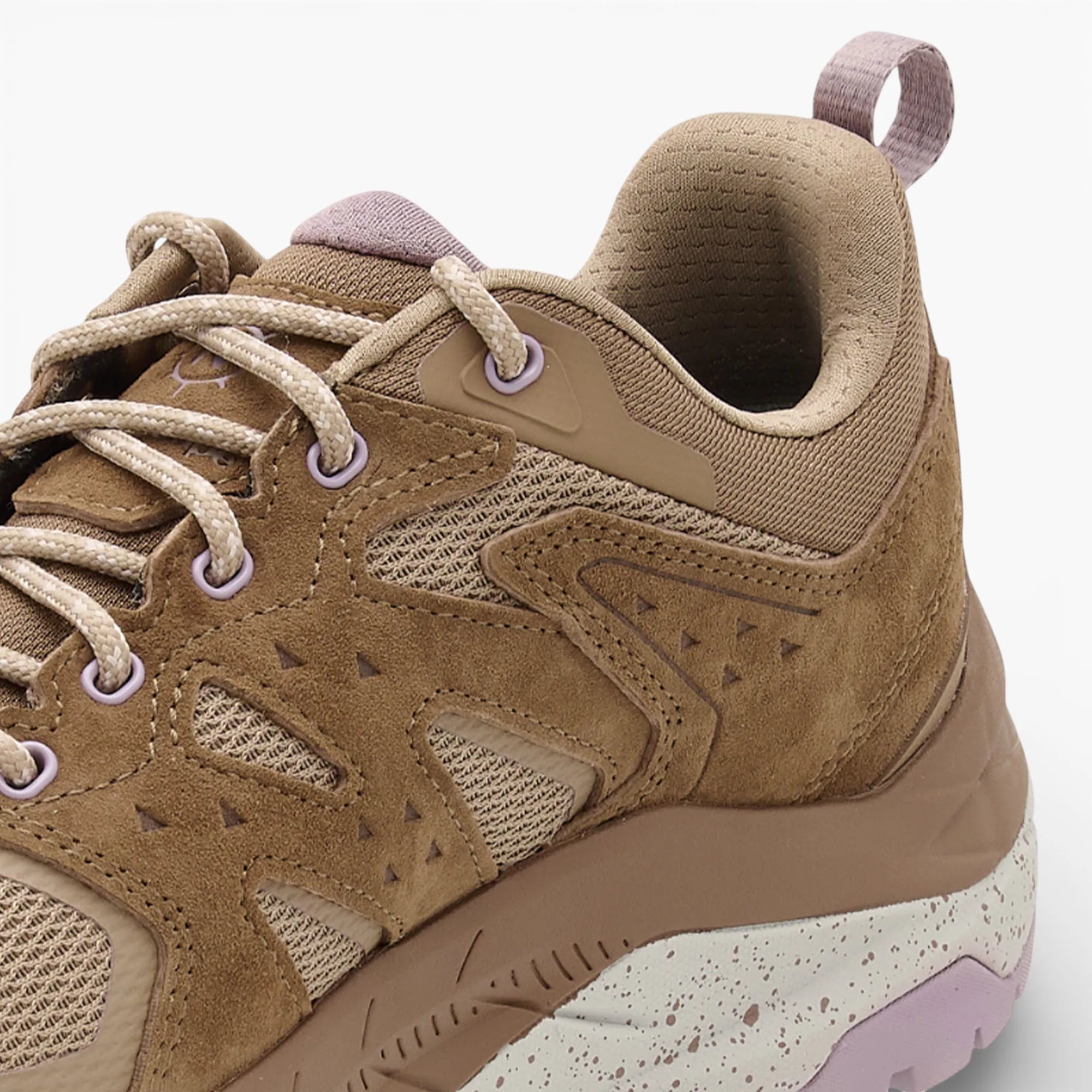 Brown hiking shoe with pink accents on a white background