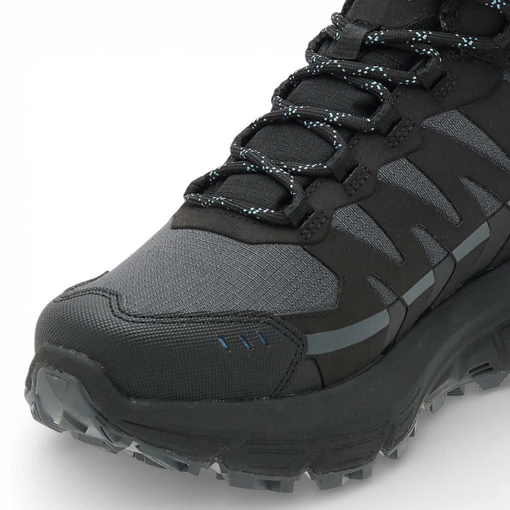 Black and gray hiking boot with textured sole on a white background
