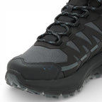 Black and gray hiking boot with textured sole on a white background