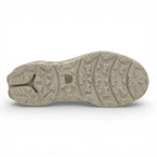 Close-up of a beige shoe sole with tread pattern on a white background