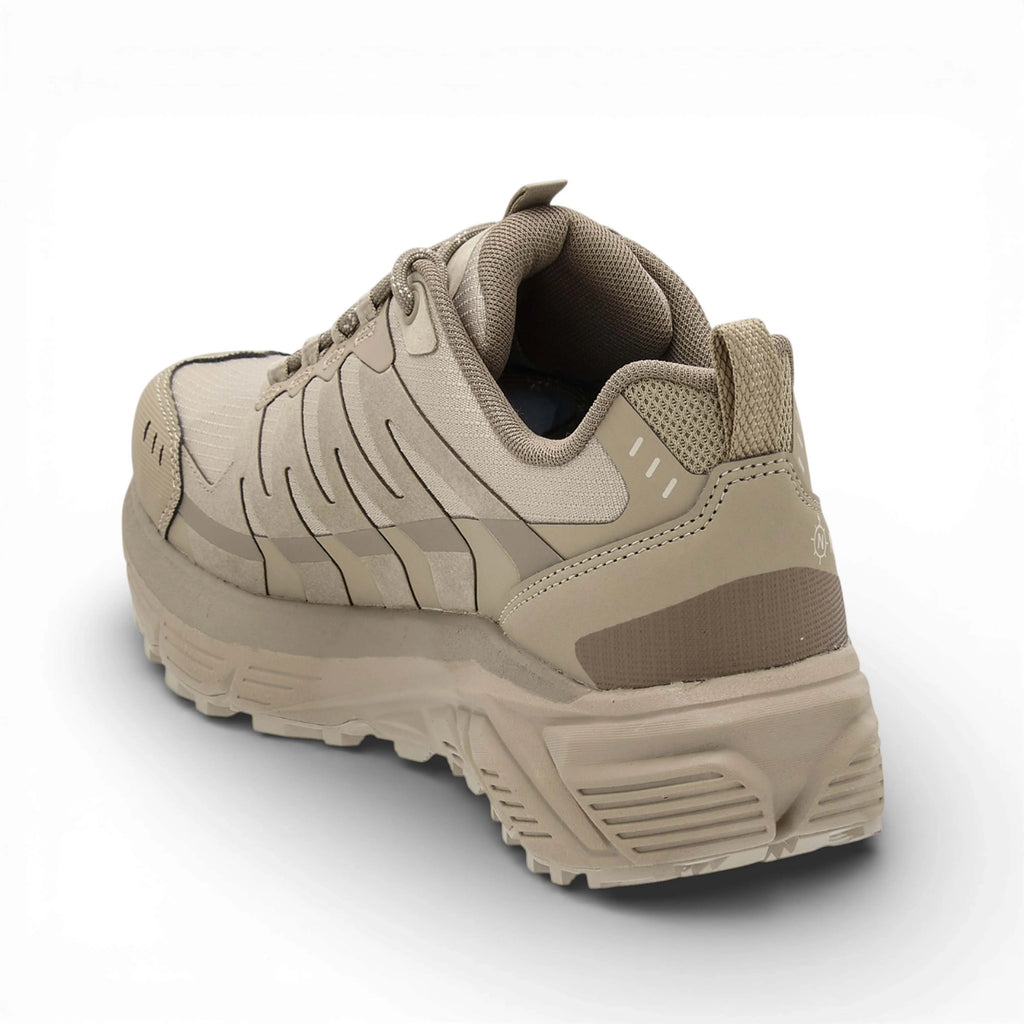 Beige sneaker with a textured sole on a white background