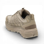 Beige sneaker with a textured sole on a white background